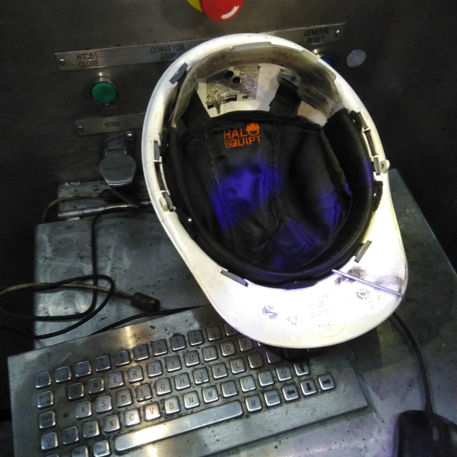 A HALO Lid Liner fitted inside a hard hat on a worksite control panel
