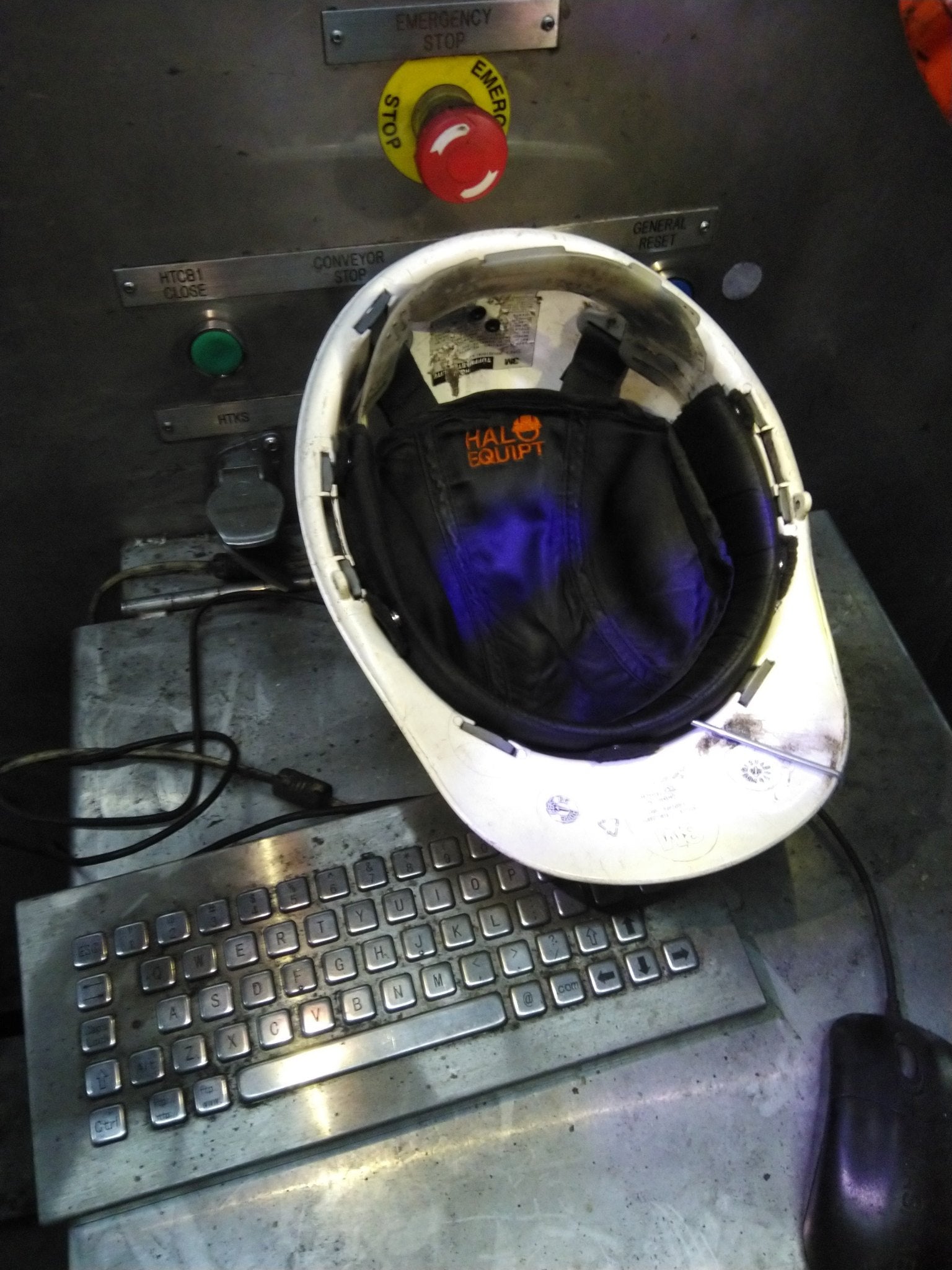 A HALO Lid Liner fitted inside a hard hat on a worksite control panel